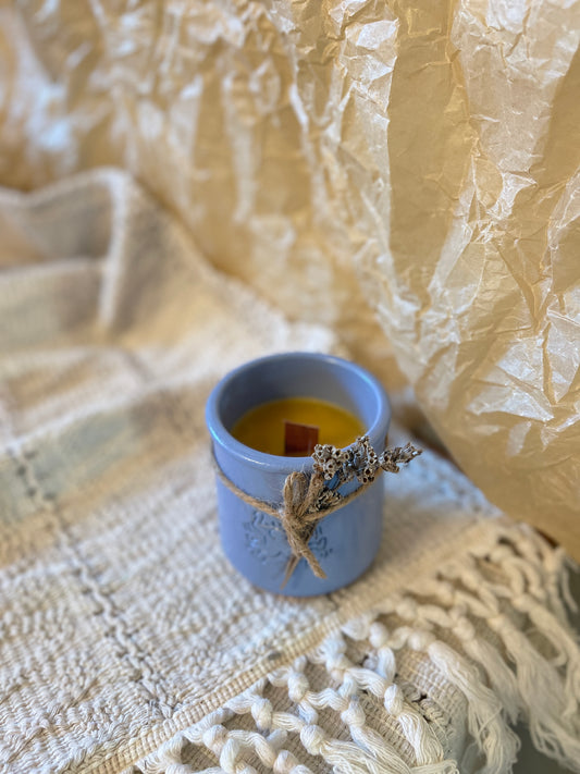 Beeswax candle in ceramic jar
